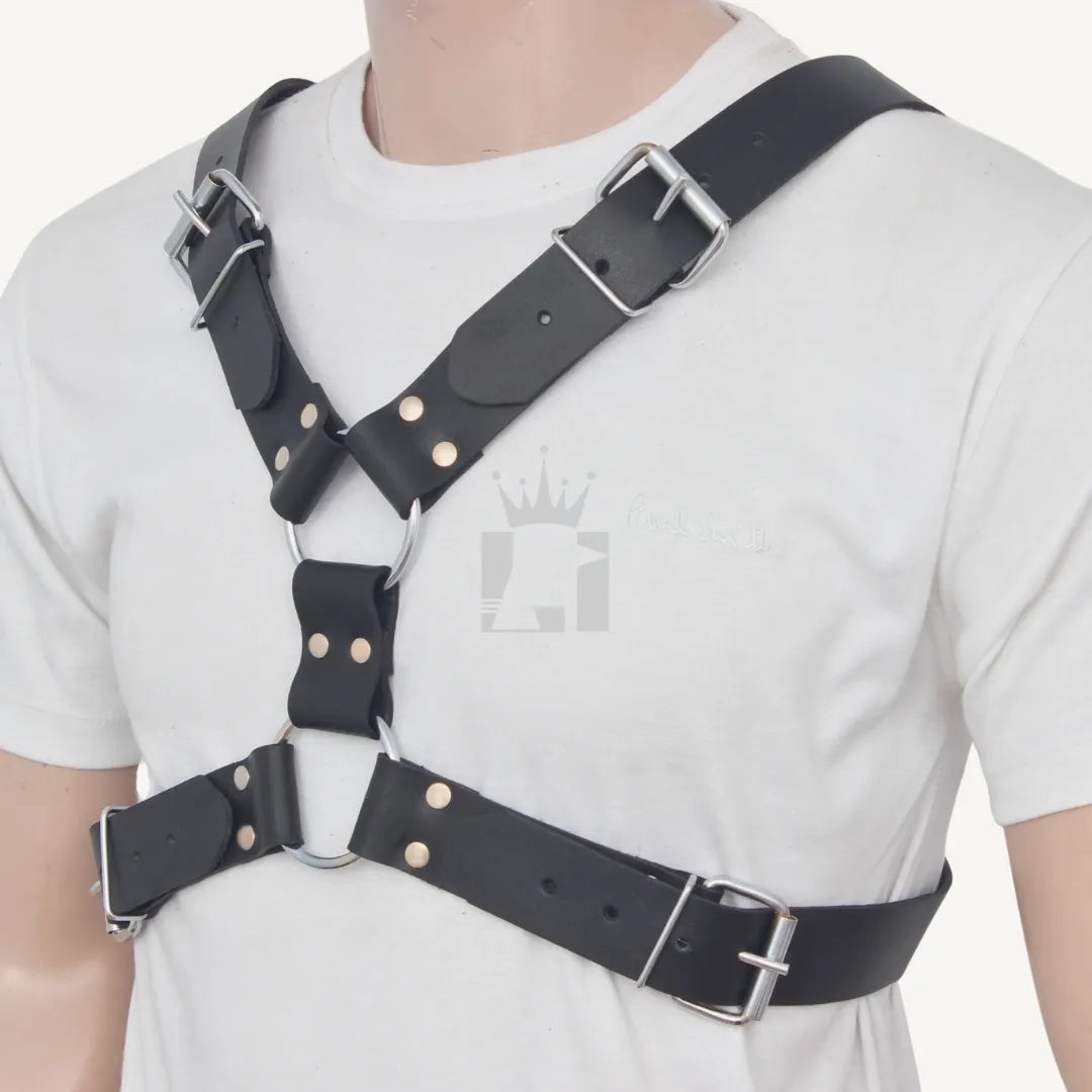 Angled front view of black leather harness with cross-strap design, worn over a white t-shirt.