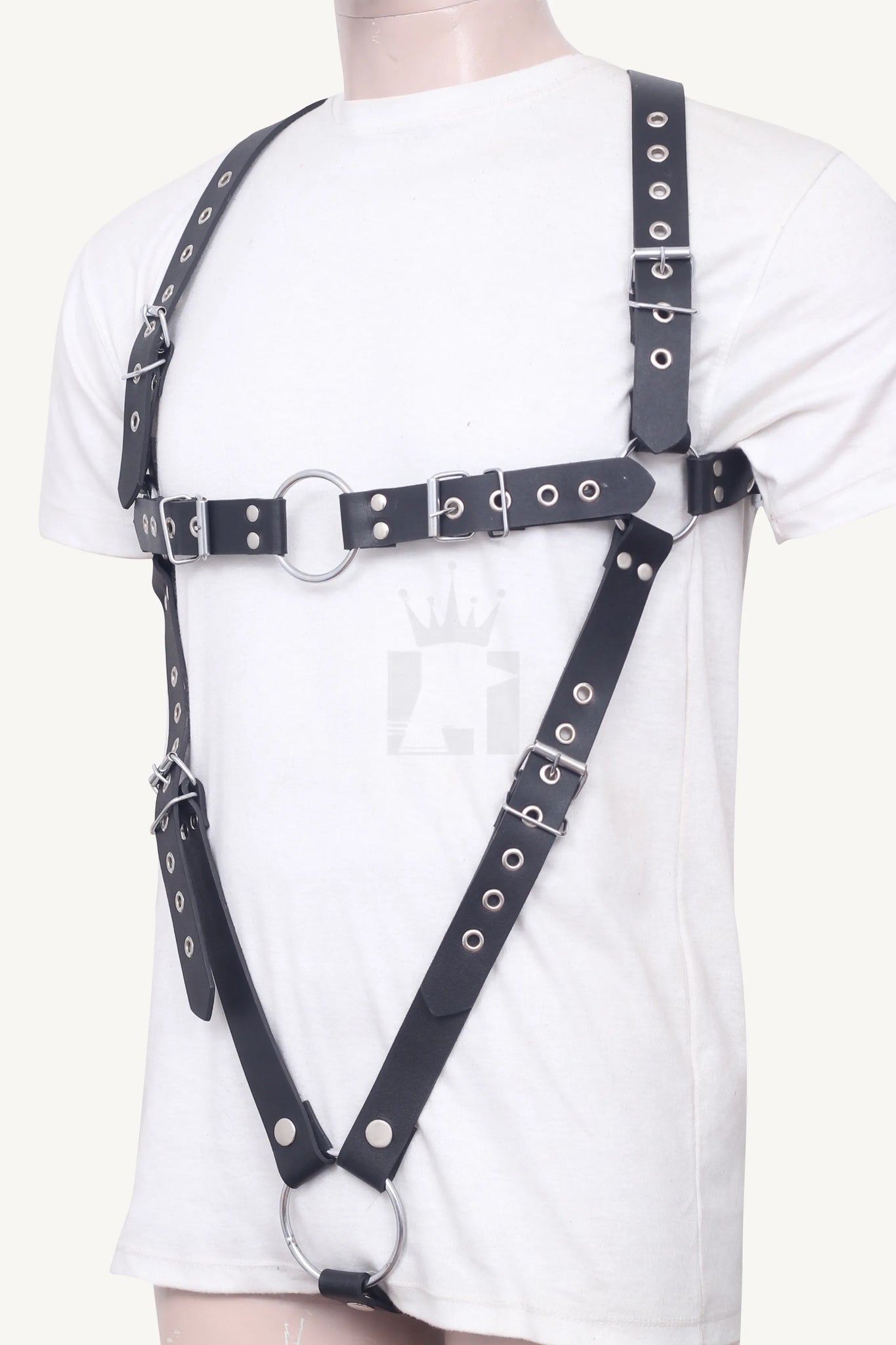 Angled front view of adjustable black leather harness featuring metal O-rings and riveted straps.