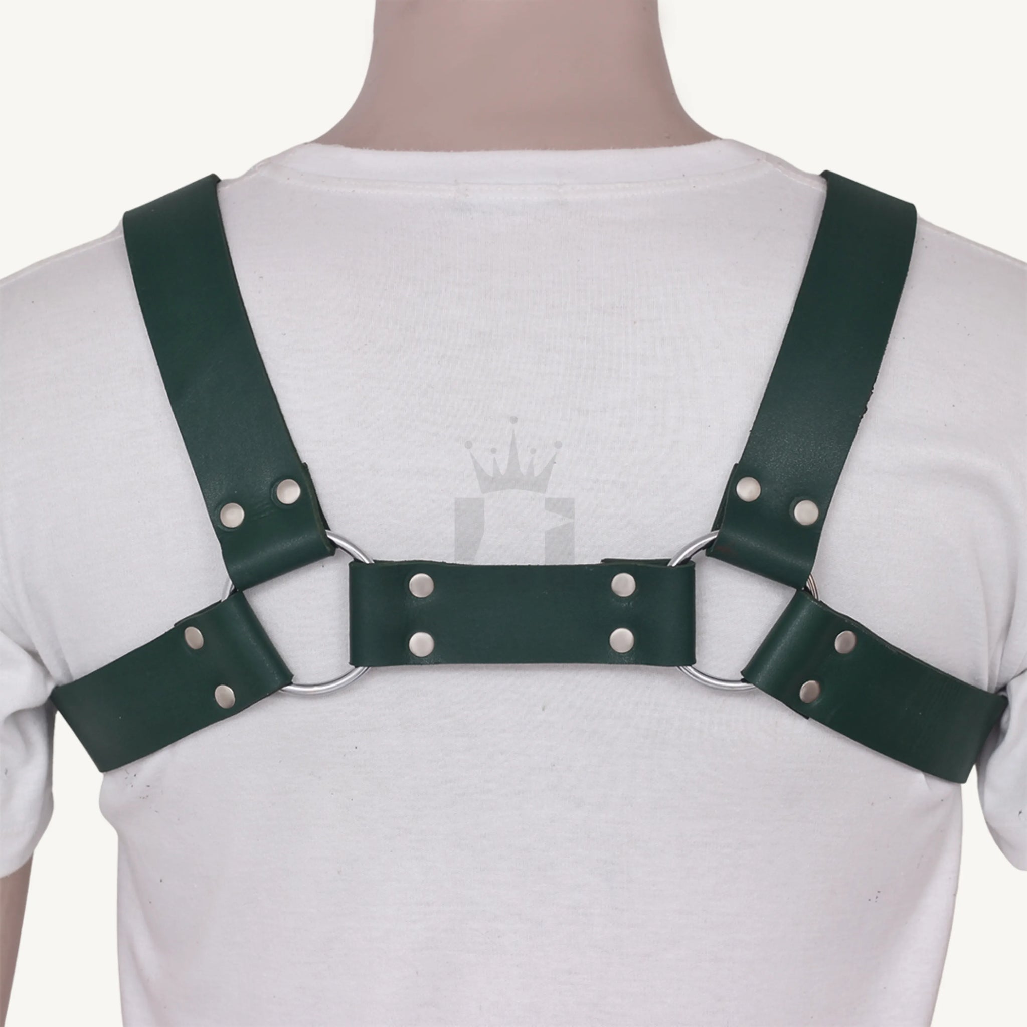 Rear view of leather chest harness with riveted straps and silver O-rings.