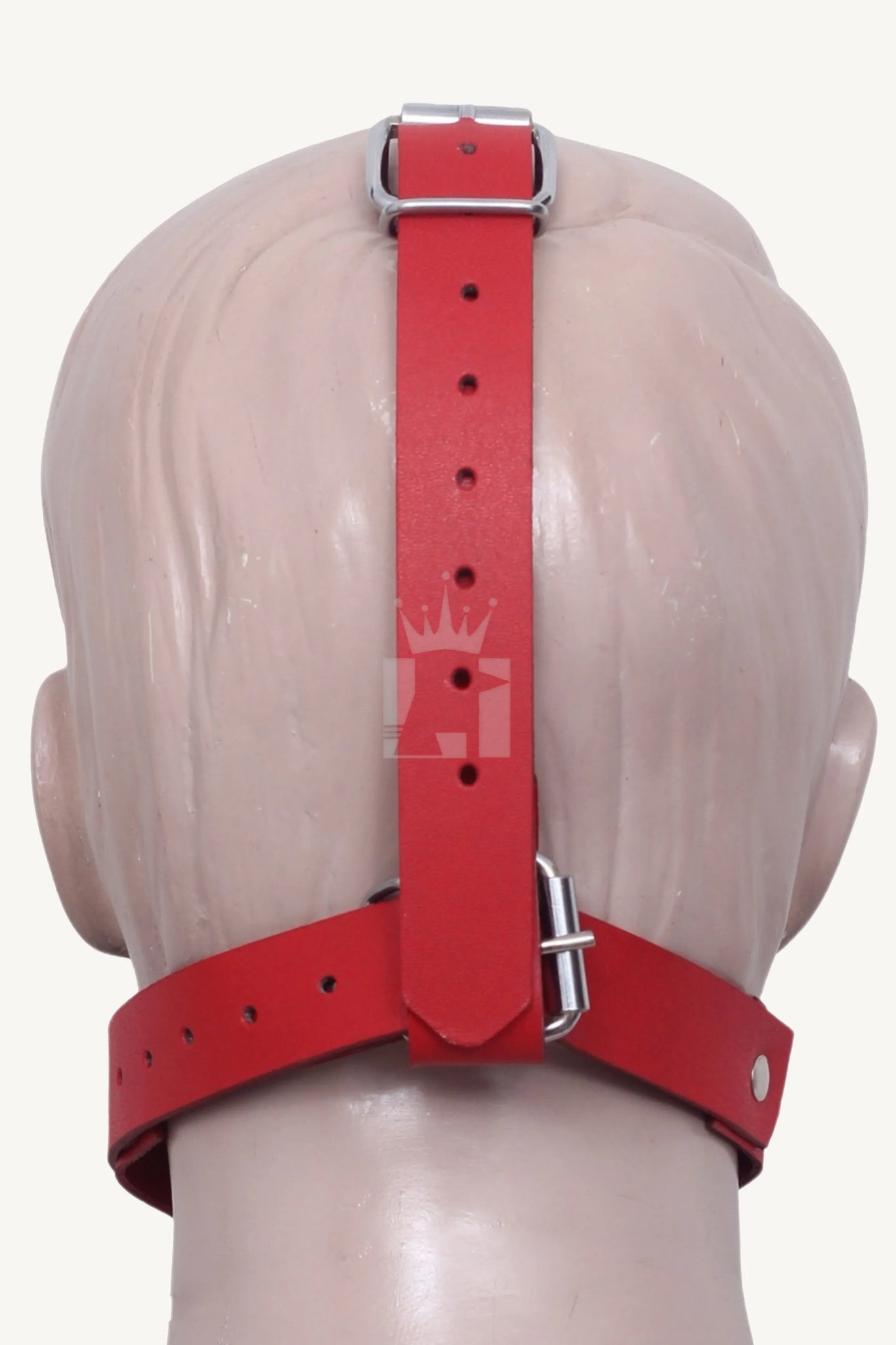 Back view of red leather bondage muzzle showing adjustable straps and silver buckle.