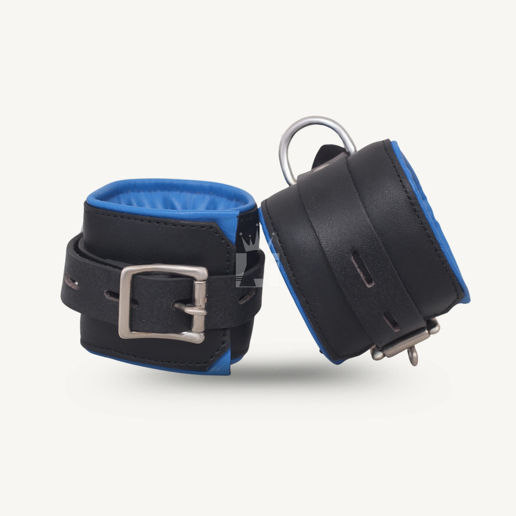 Close-up of padded wrist cuffs in black leather with blue interior, featuring metal buckle closure and strong side D-rings.