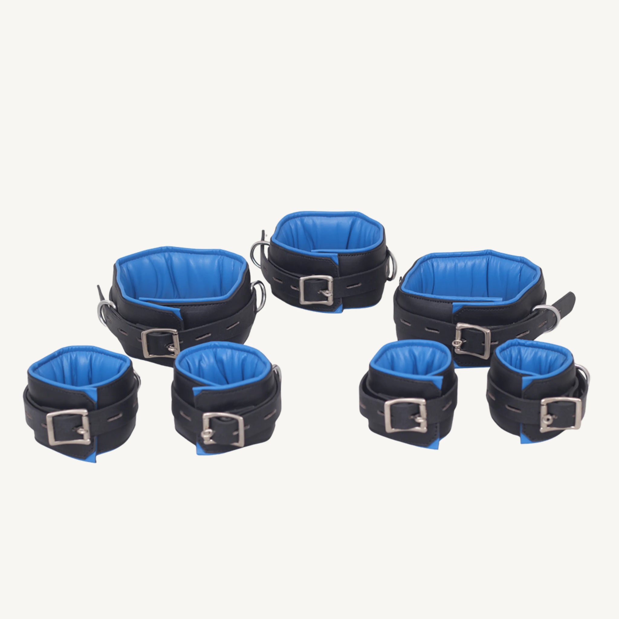 Display of seven-piece leather bondage set with blue padding, including collar, wrist, ankle, and thigh cuffs.