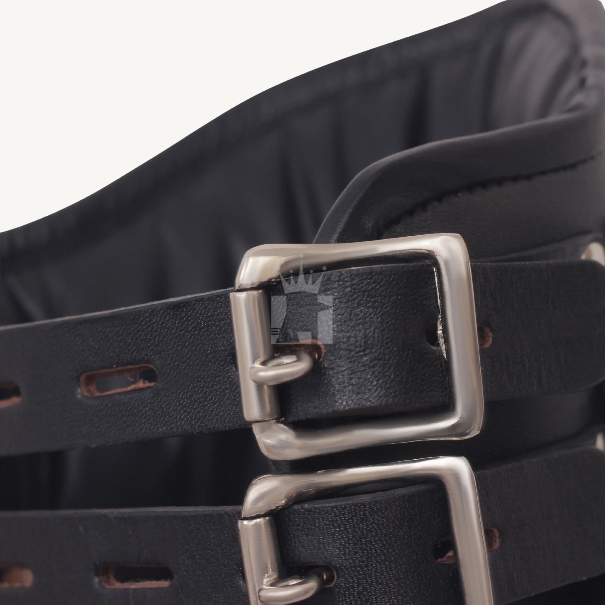 Close-up of adjustable buckle straps on black leather bondage neck collar.