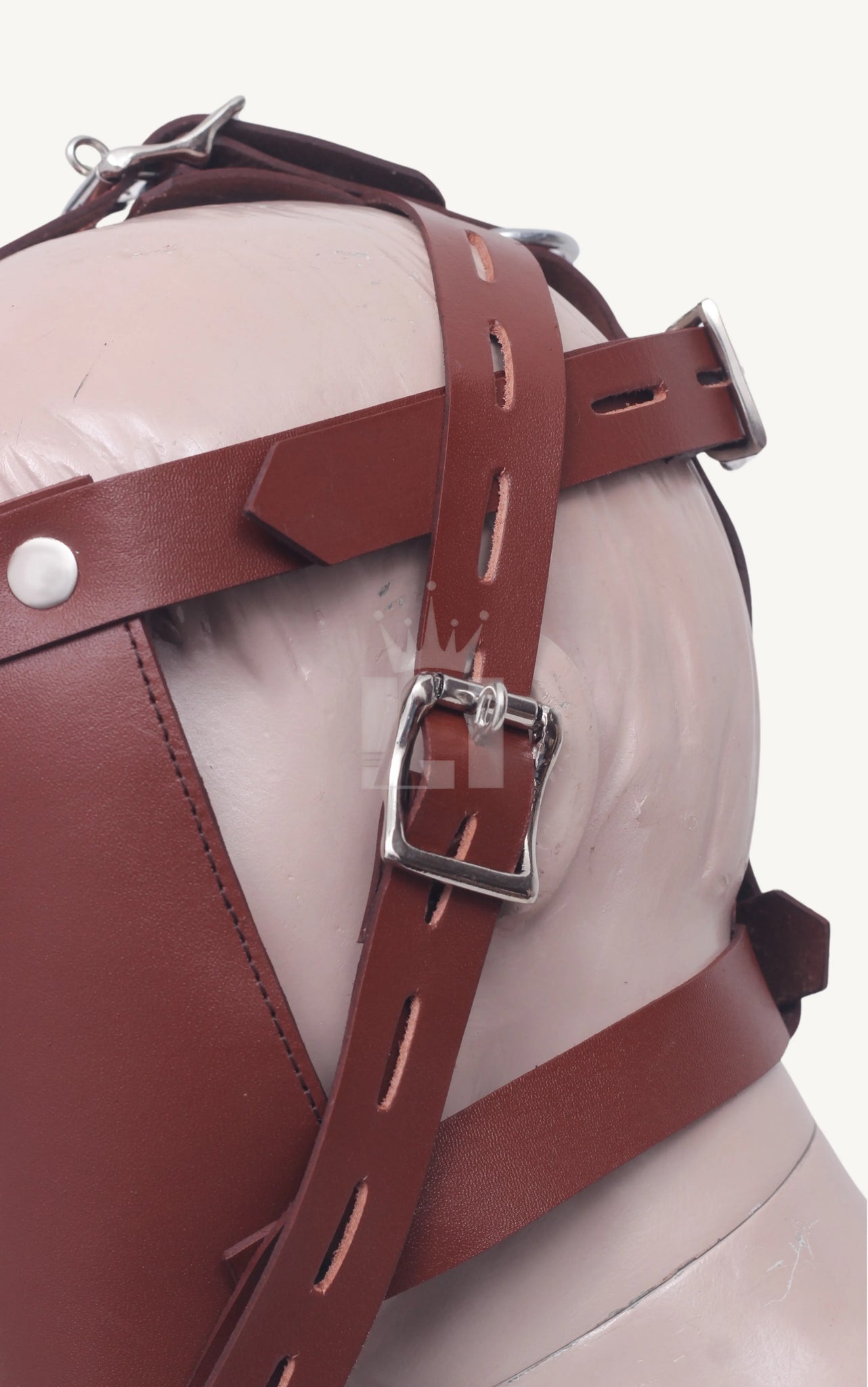 Back view of a mannequin head with brown leather bondage muzzle featuring adjustable buckle straps.