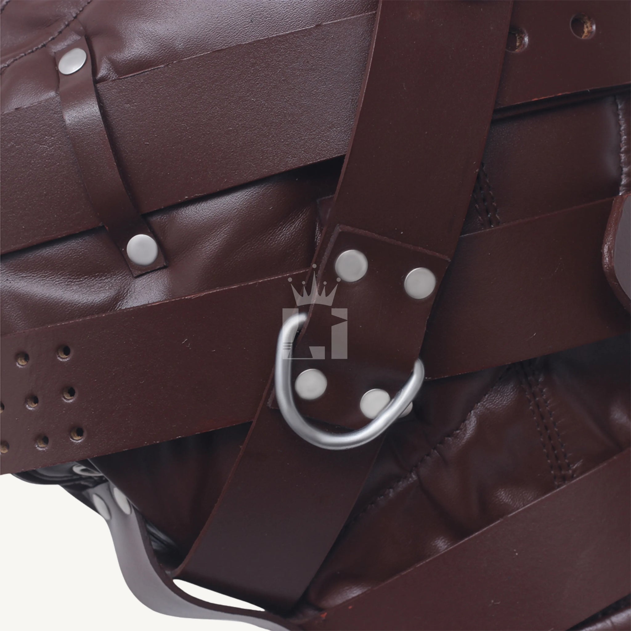 Close-up of silver D-ring fixed with rivets to the strap of brown leather bondage hood.