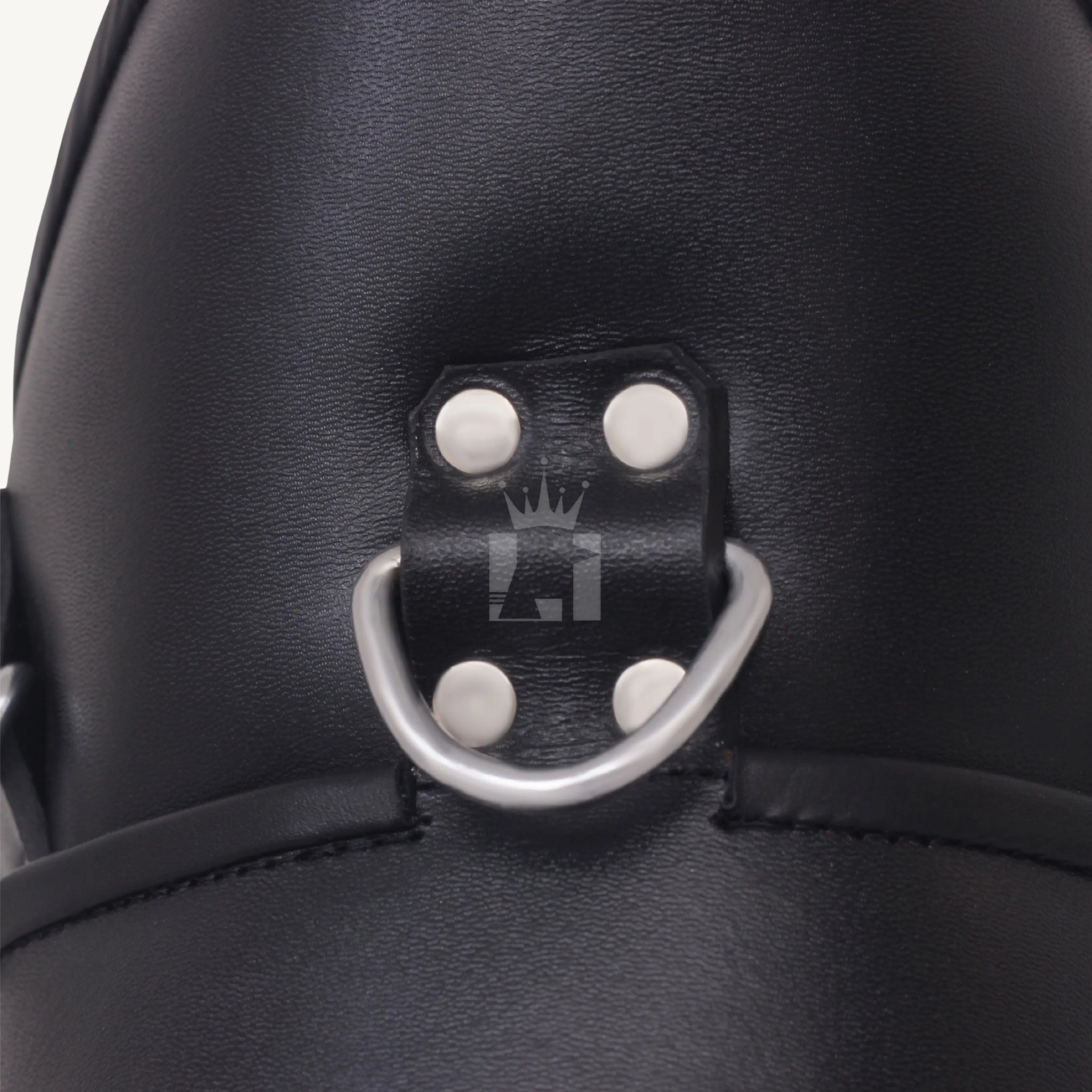 Detailed view of silver D-ring riveted onto black leather bondage collar.