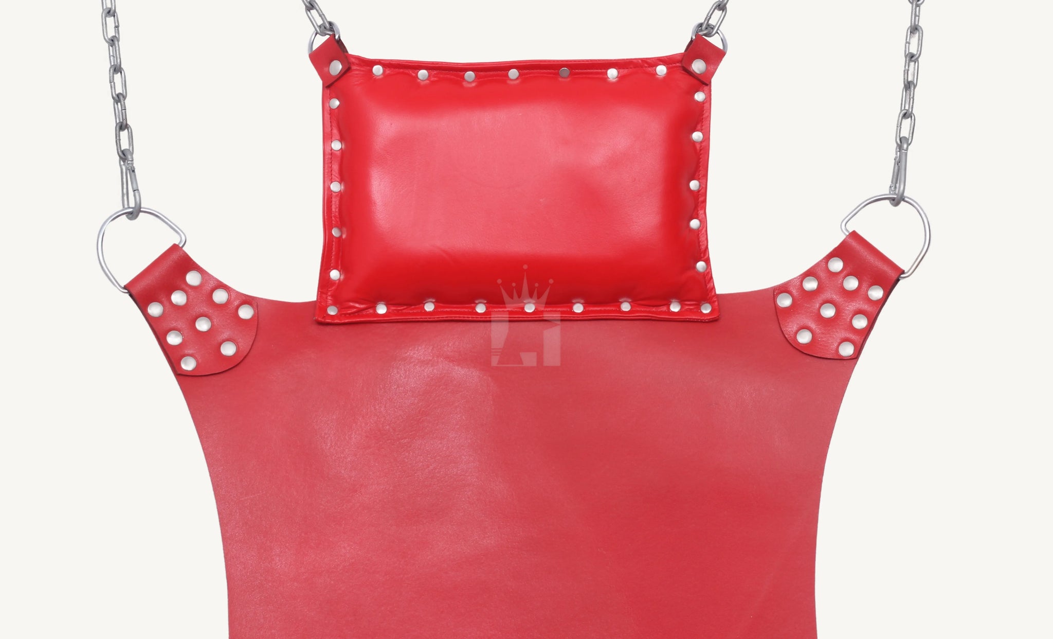Detailed upper view of padded pillow attached to red leather sex sling with riveted corners and D-rings.