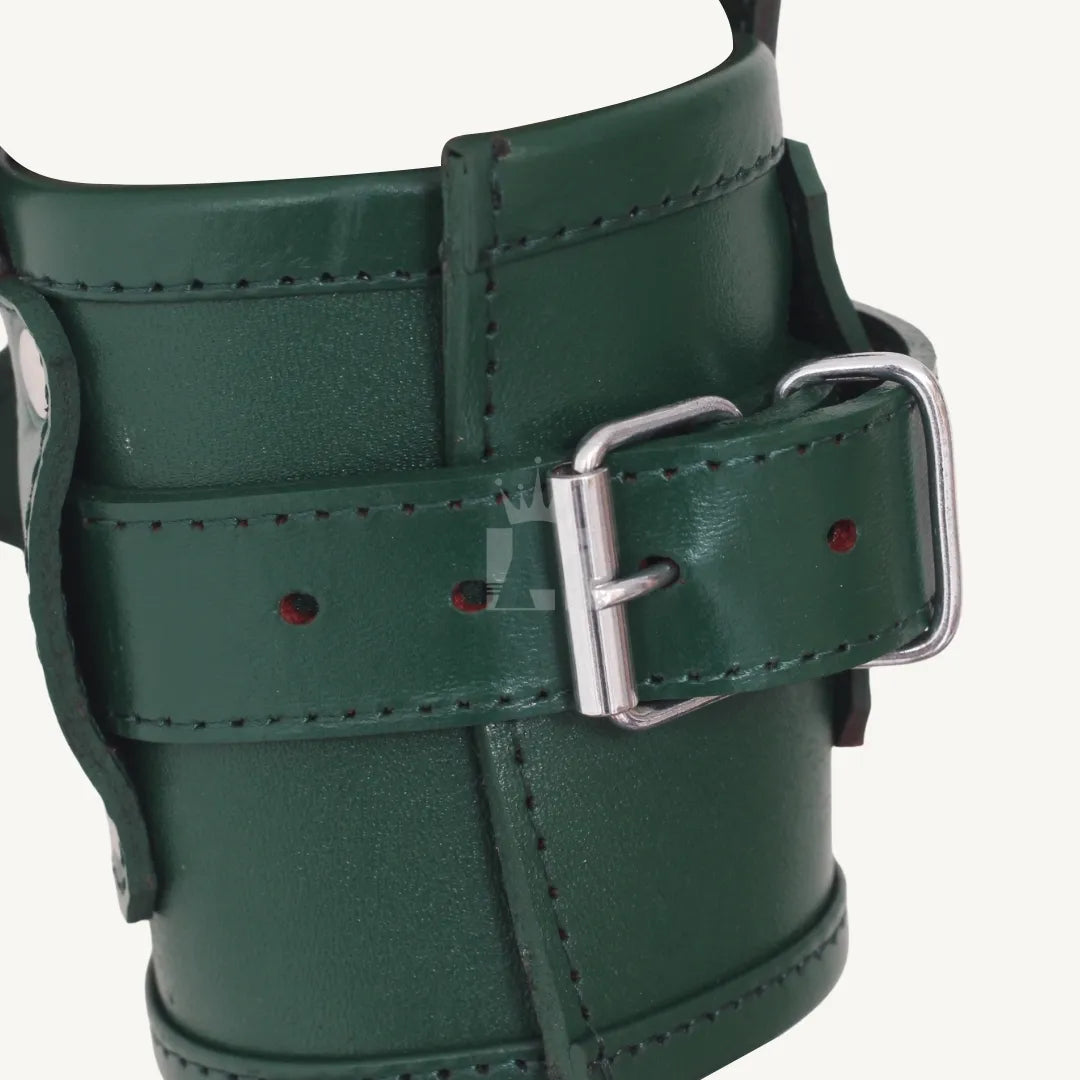 Close-up side view of green leather wrist cuff showing silver buckle, stitching, and rivets.