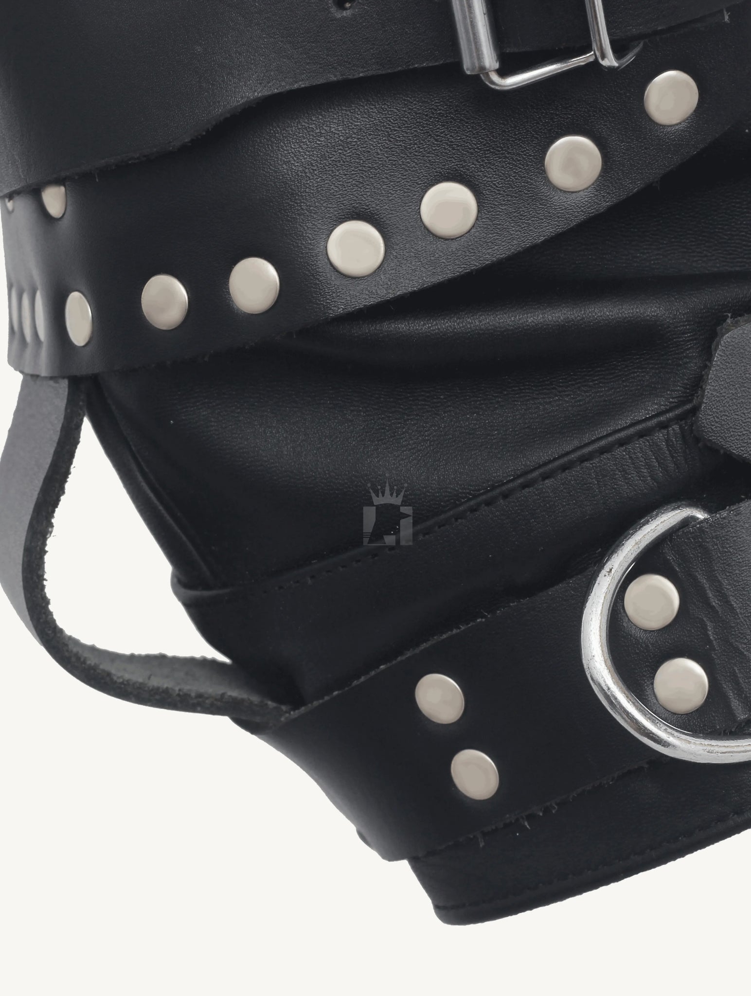 Close-shot of a black leather bondage hood side with d'ring and revets with strap on a w white background
