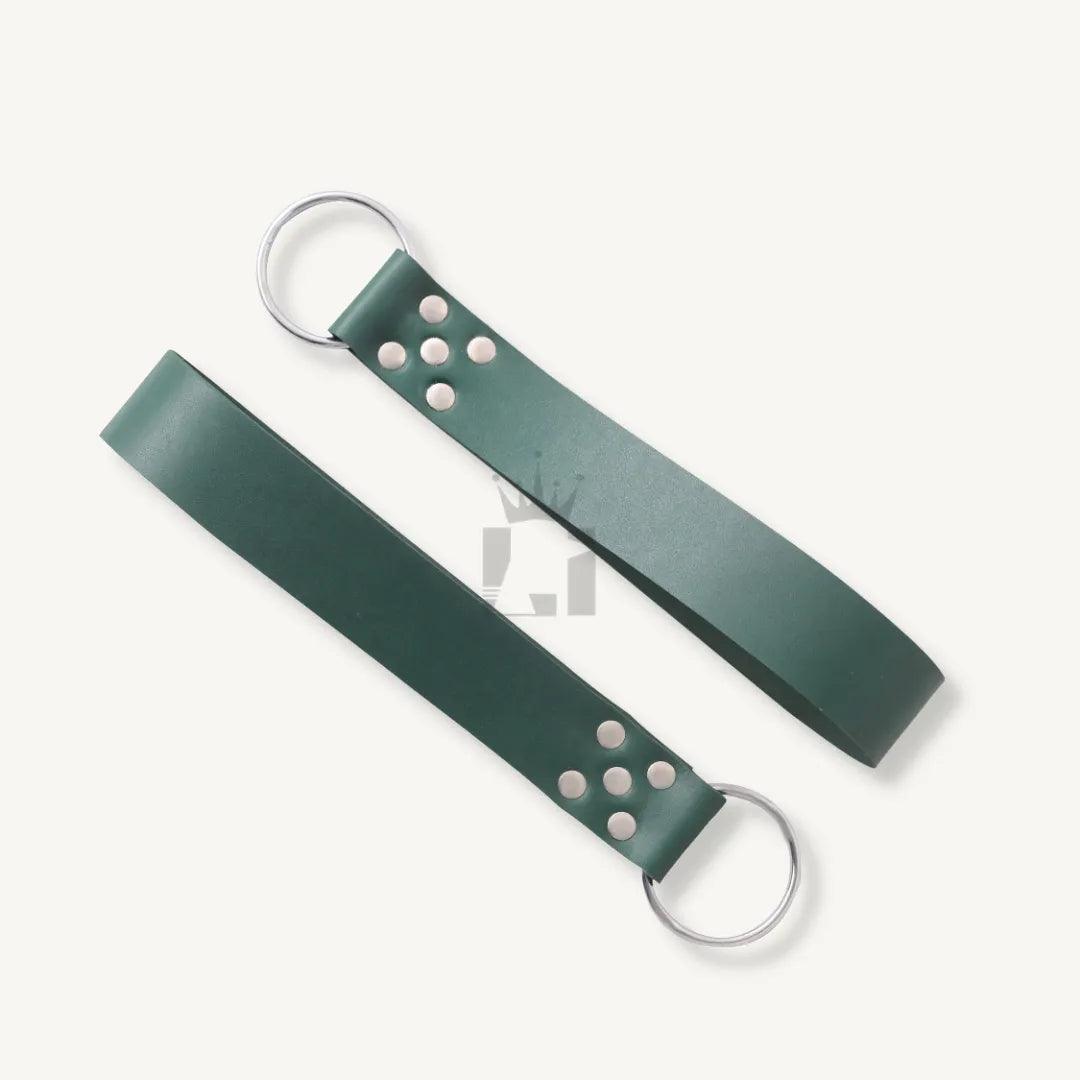 Pair of detachable green leather straps with O-rings and rivets for bondage sling suspension.