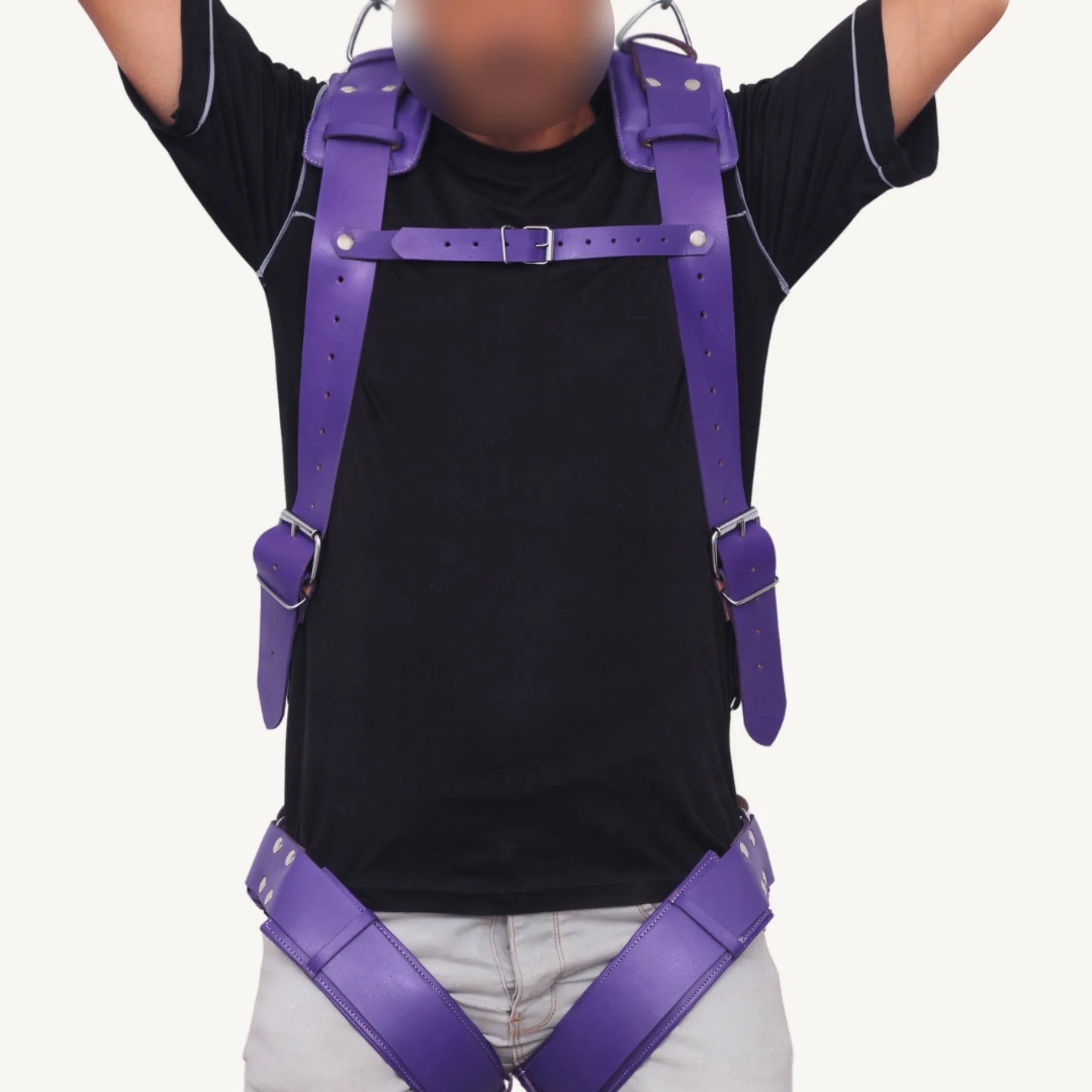 Front view of a man wearing a purple genuine leather Sex sling with adjustable straps and buckles.