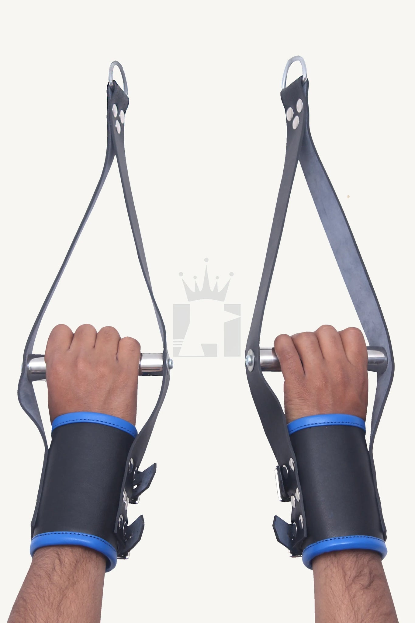 Hands wearing black leather suspension cuffs with blue edges, gripping a metal bar connected to heavy-duty hanging straps.