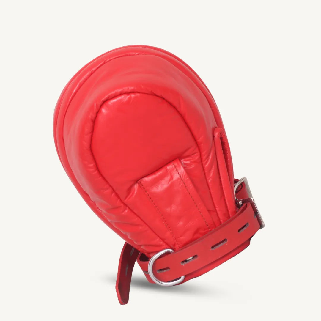 Front angled view of red leather locking mittens with padded design and adjustable buckle strap.