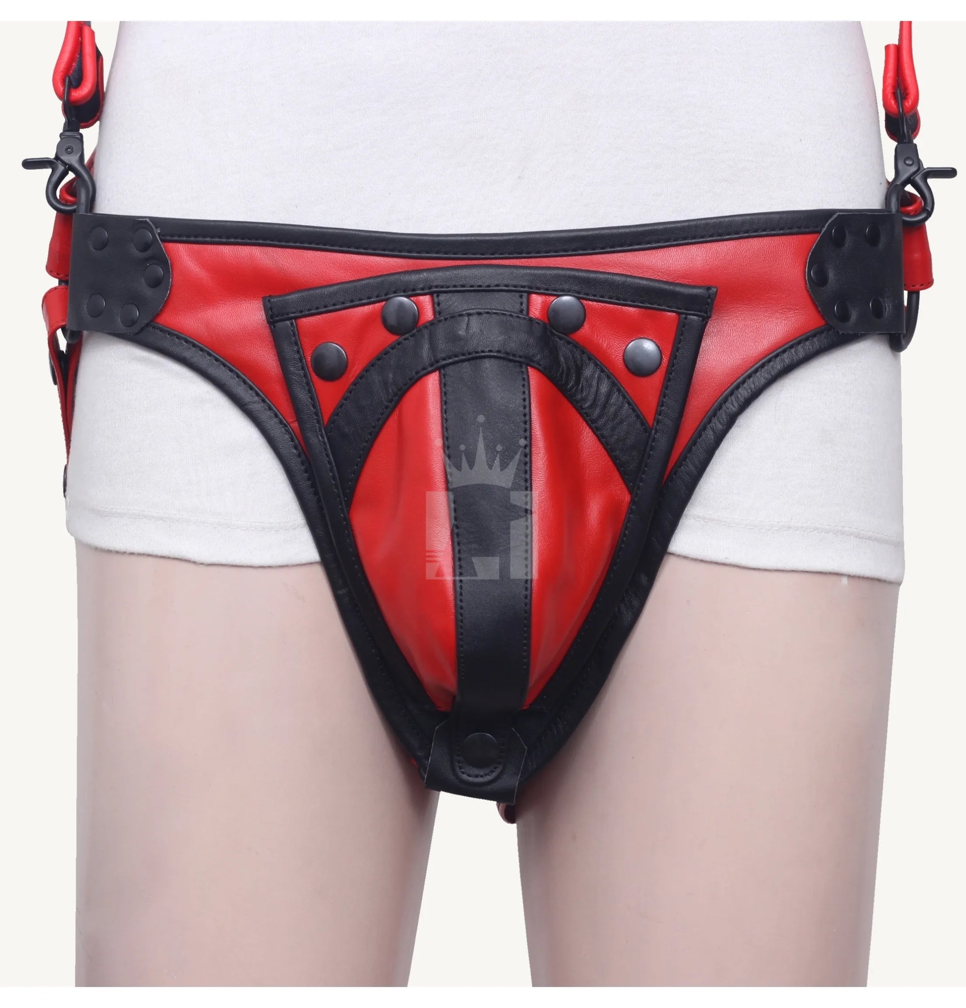 Leather codpiece in black and red with snap button design, attached to harness belt.