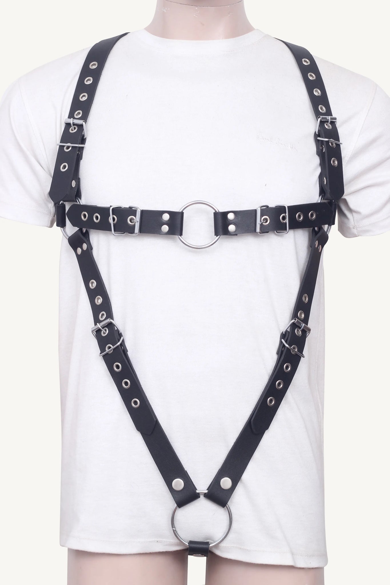 Full front display of black leather body harness with multiple buckles, O-rings, and adjustable straps.