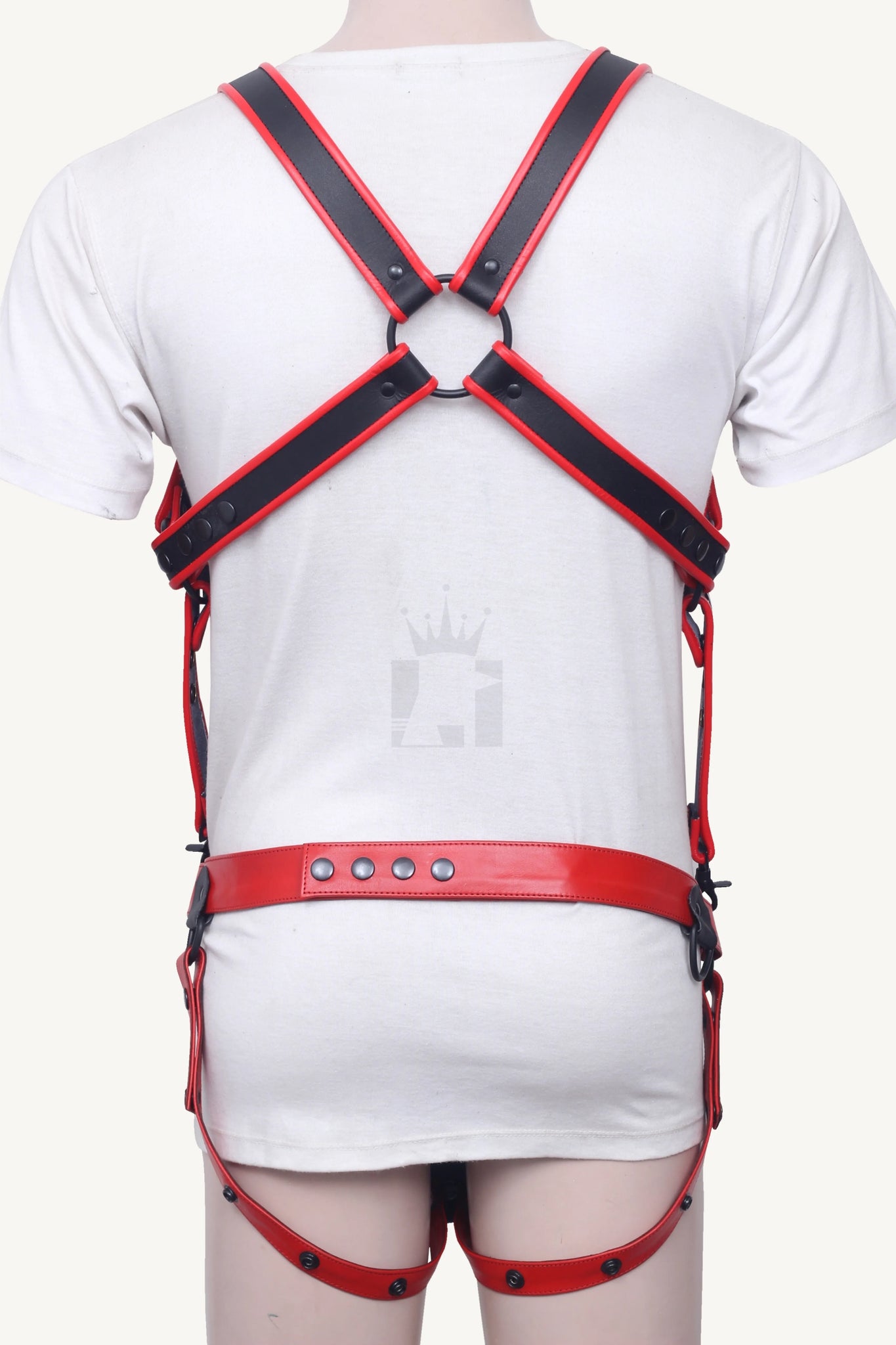 Rear view of red leather belt and crossed harness straps forming an X shape on the back.