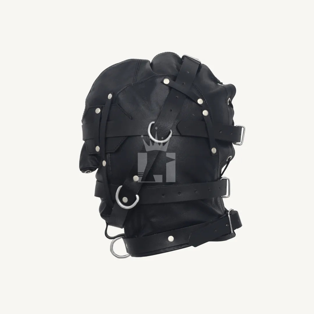Left side view of black leather bondage hood showing layered straps, buckles, and metal rings.