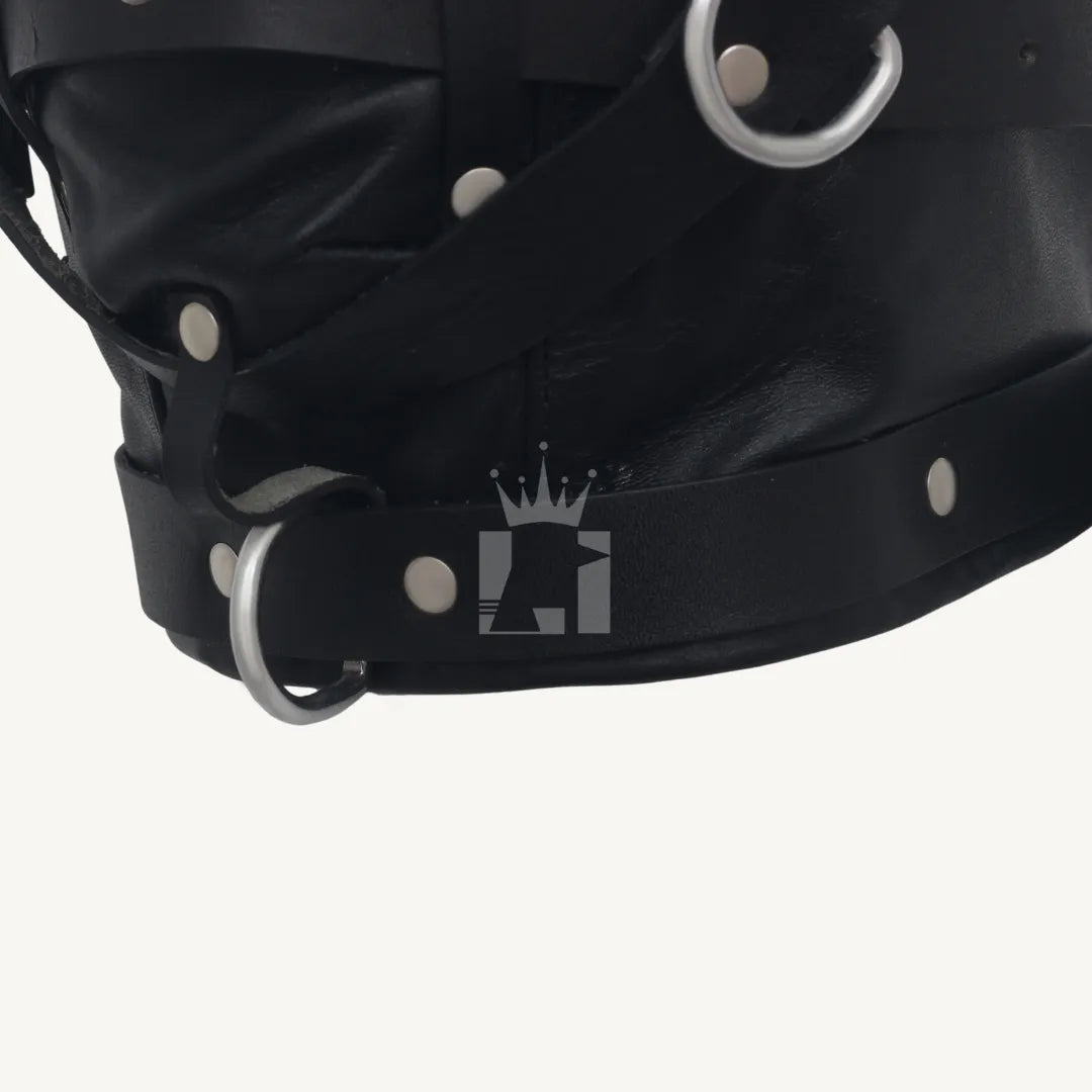 Close-up of the bottom section of black leather hood featuring strap, rivets, and D-ring hardware.