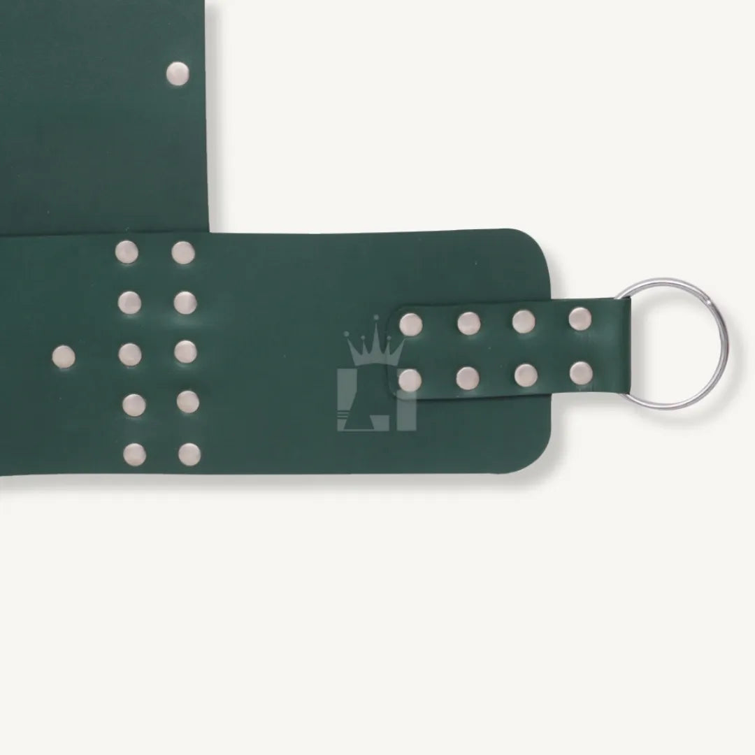 Close-up of silver O-ring attached with riveted strap on green leather bondage sling.