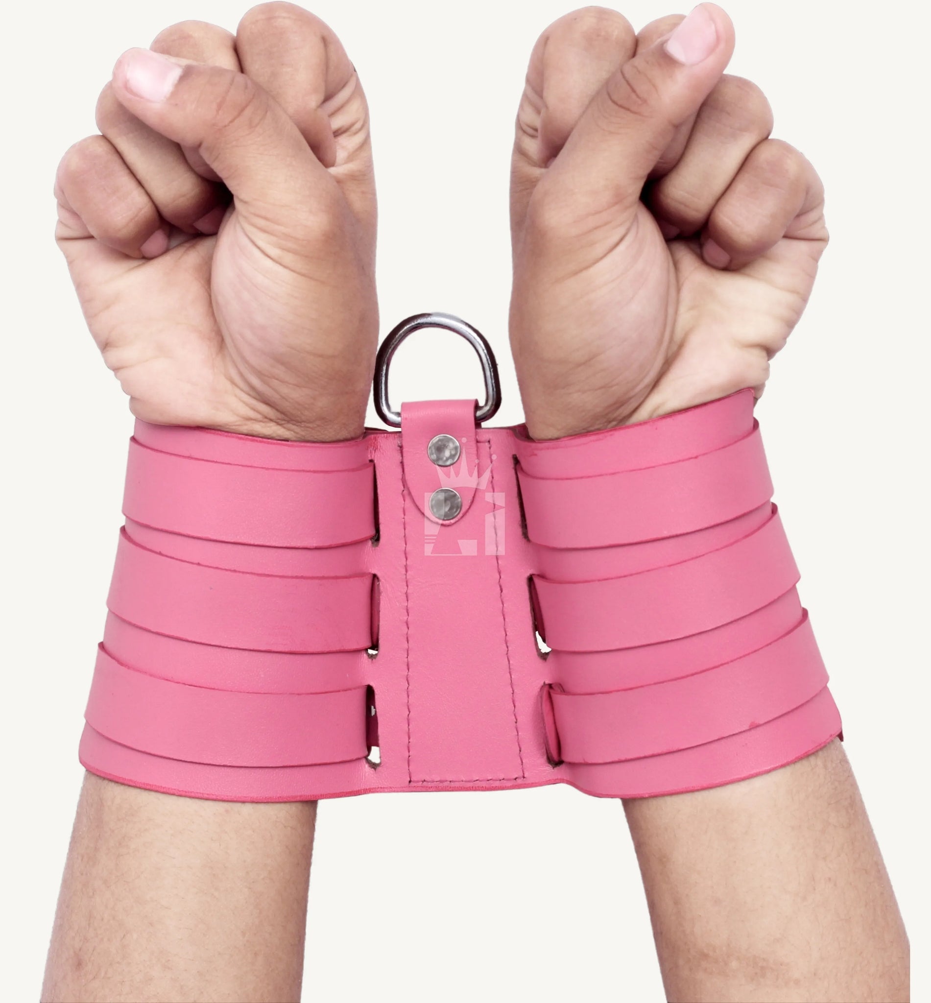 Back view of pink leather handcuffs with wide straps and a metal D-ring connecting the cuffs.