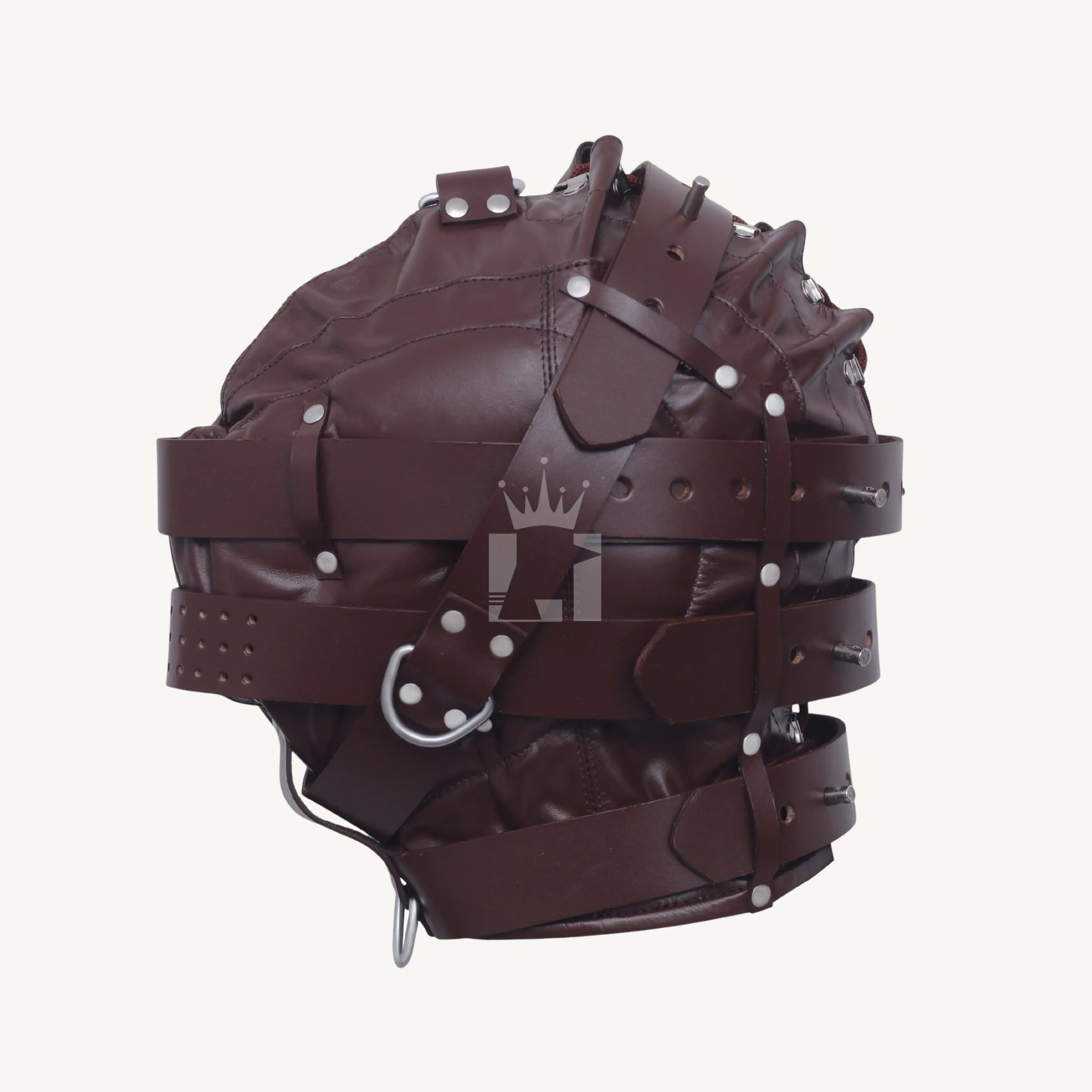 Side view of brown leather bondage hood with layered straps, D-rings, and silver rivet details.