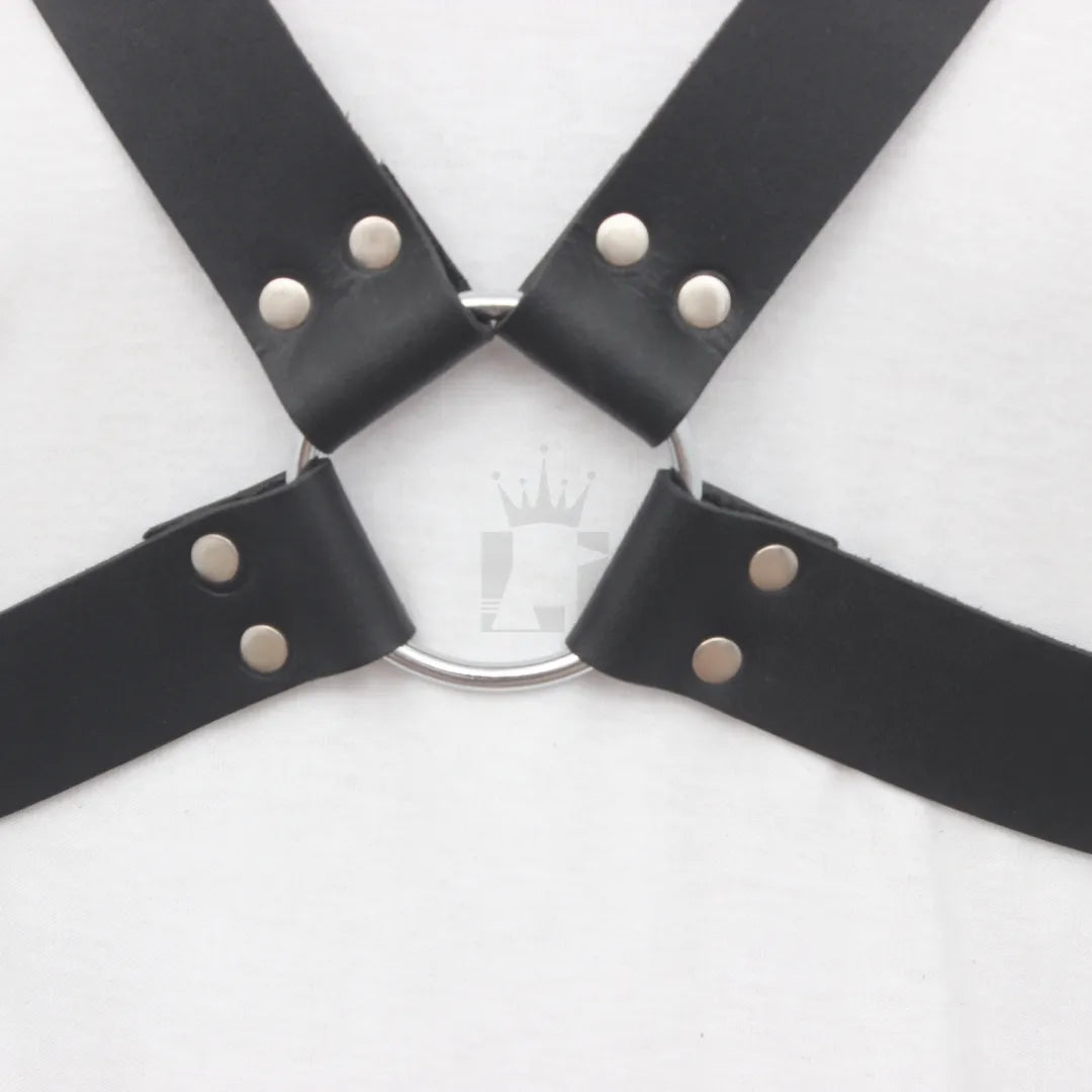 Close-up showing riveted O-ring connection on leather harness straps.