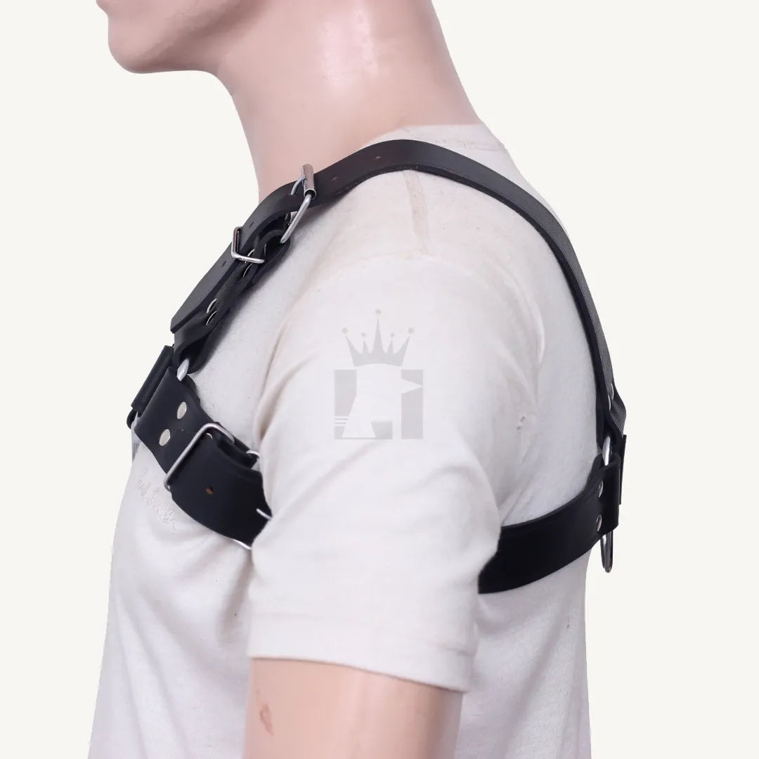Side view of black leather chest harness showing adjustable buckle strap and O-ring connection.