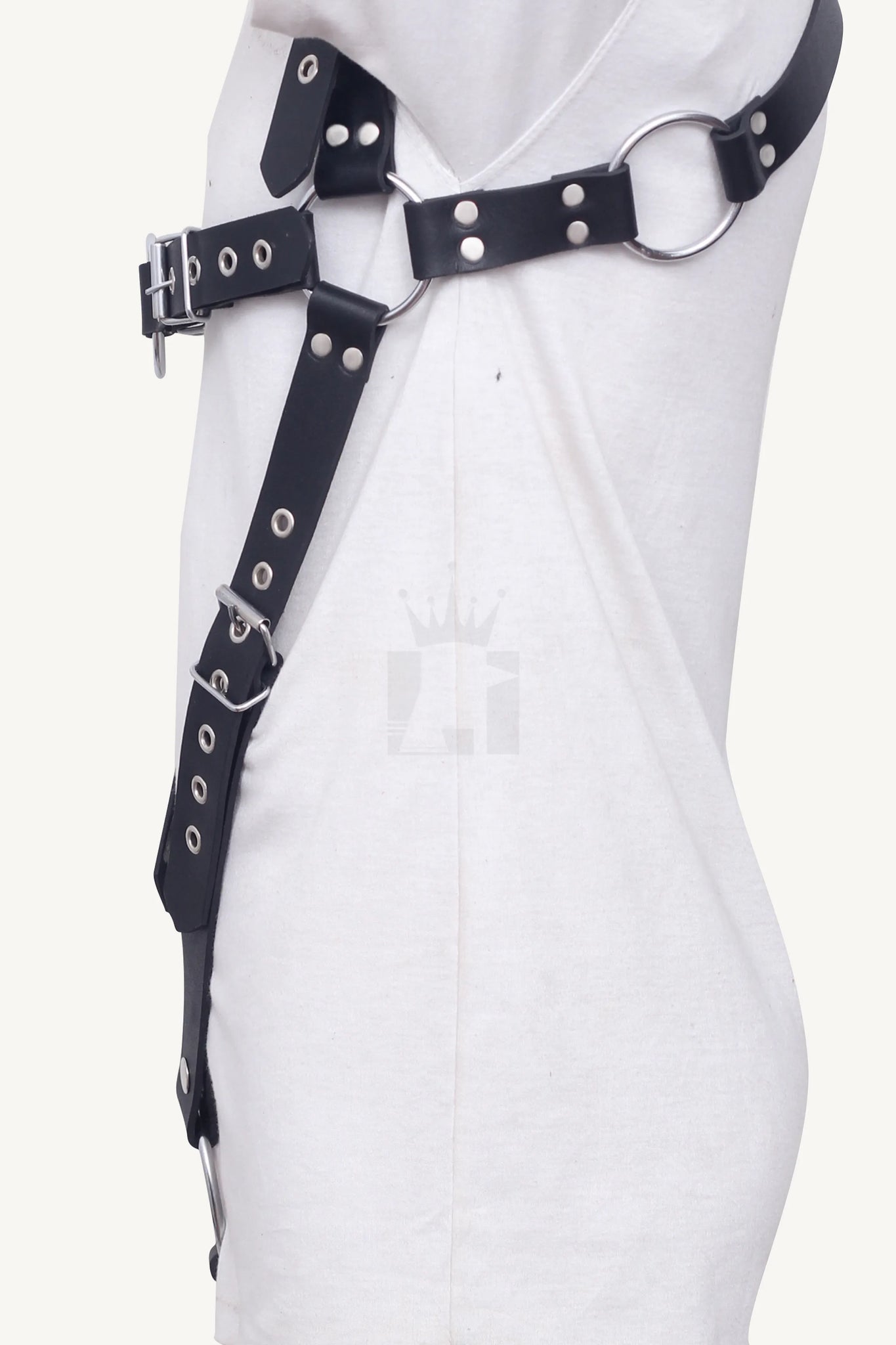 Side profile of black leather harness with O-rings, buckles, and adjustable straps.