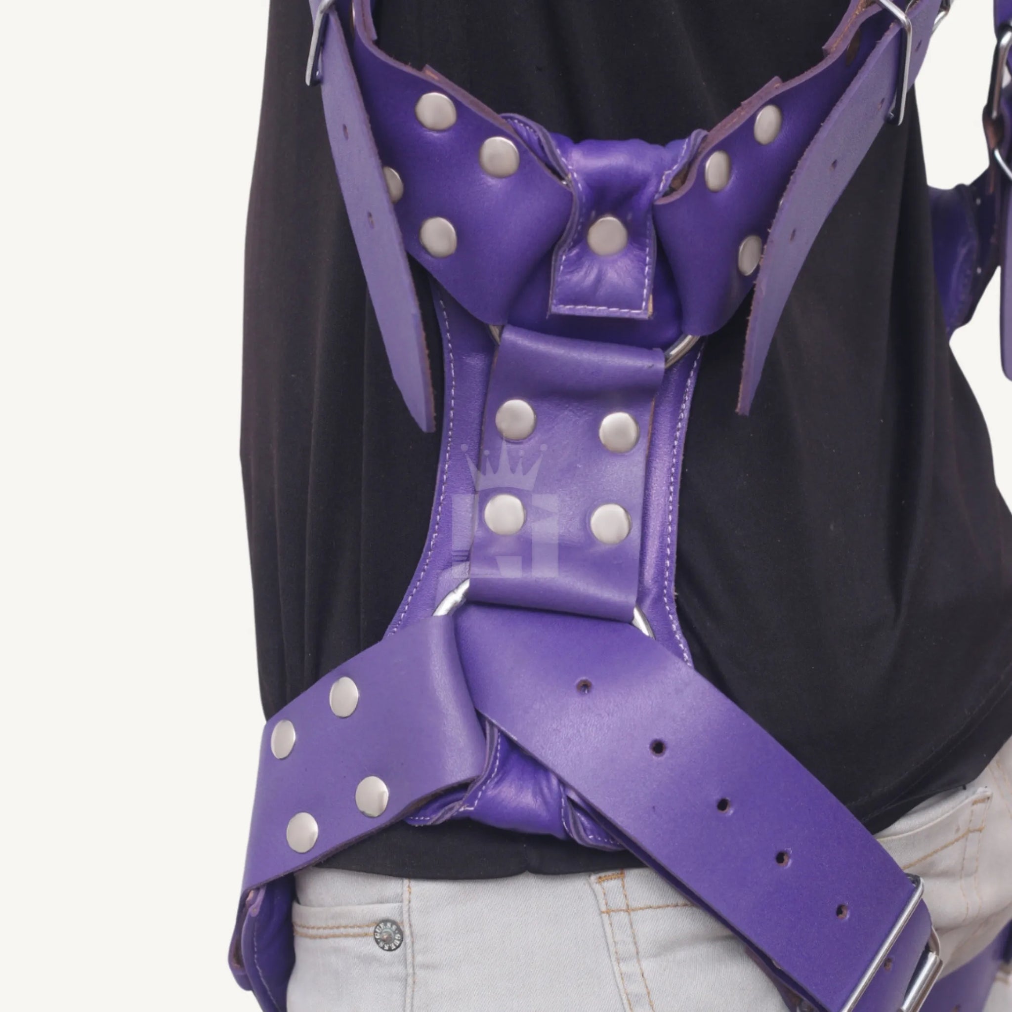 Side close-up of purple leather sex sling showing riveted construction, straps, and secure buckle design.