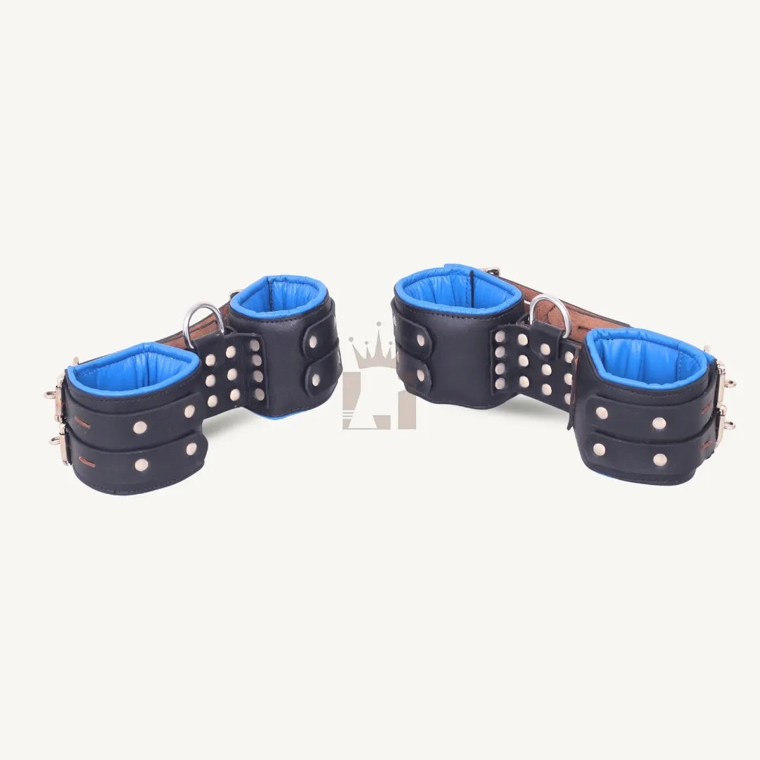 Pair of black leather suspension cuffs with blue padded lining and D-ring attachment, displayed side by side.