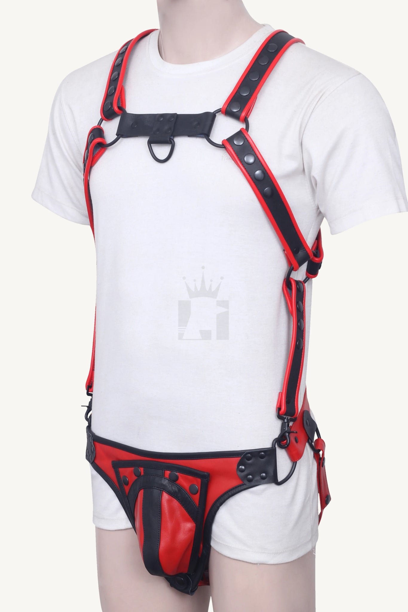 Model side view showing full leather harness with shoulder straps, codpiece, and waist belt.