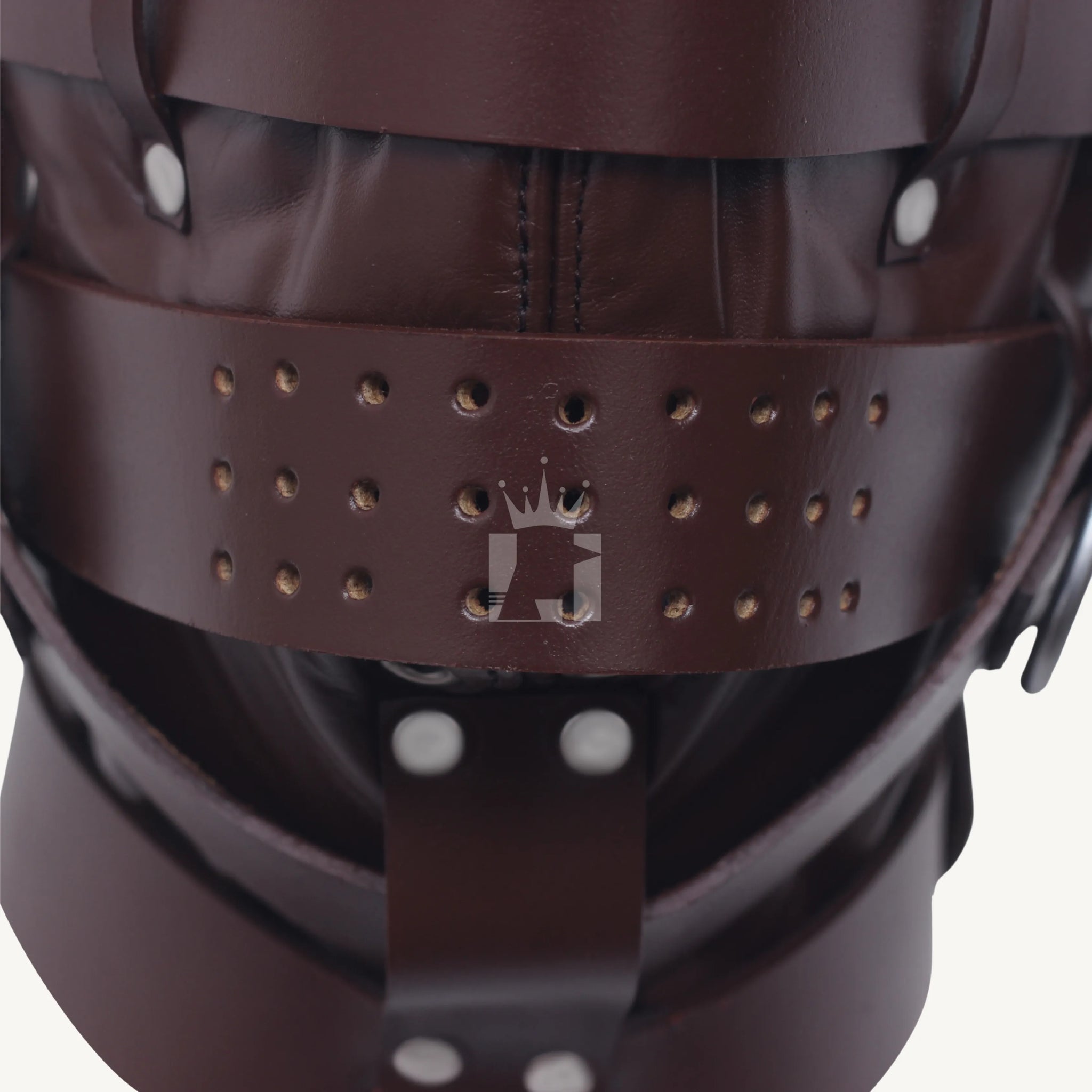 Close-up view of perforated brown leather strap across the mouth area of bondage hood.