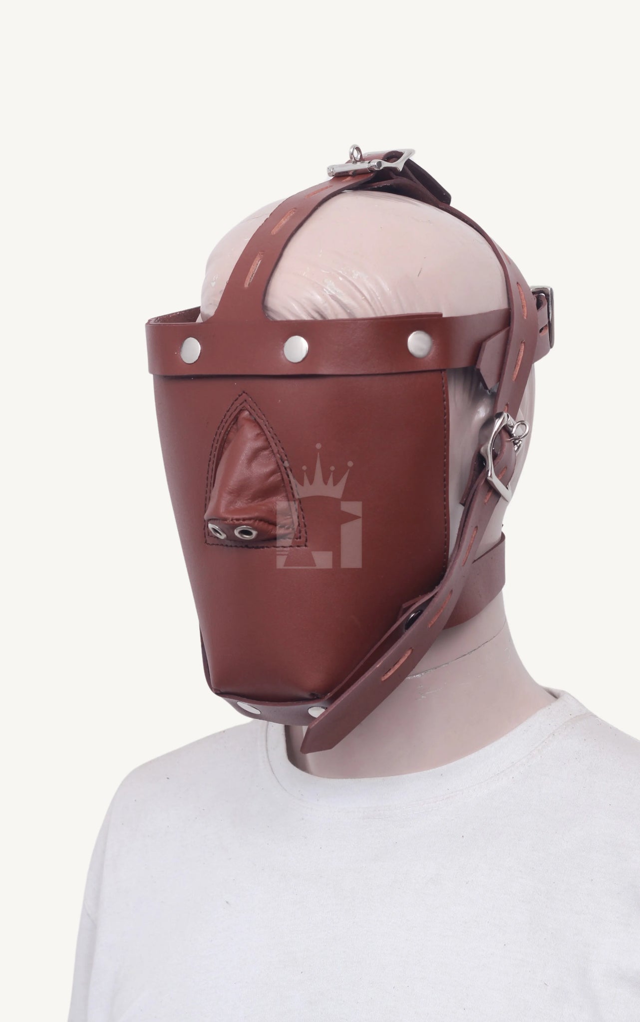 Mannequin wearing a brown leather bondage muzzle, showing nose cover and secure strap system from side angle.