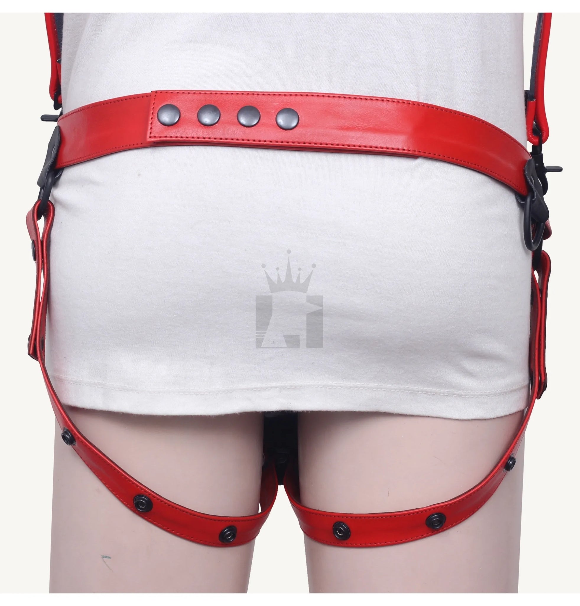 Closeup of red leather belt and leg straps with snap button fastening at the back.