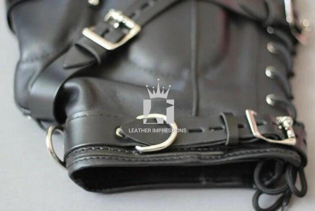 Close-up shot of a handcrafted black Leather Bondage Hood with Adjustable Straps, laces on a grey background