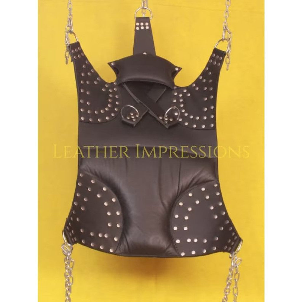 front angle view of black leather sex swing with comfort pillow, D'rings with the nickel-plated reverts on it in a yellow background