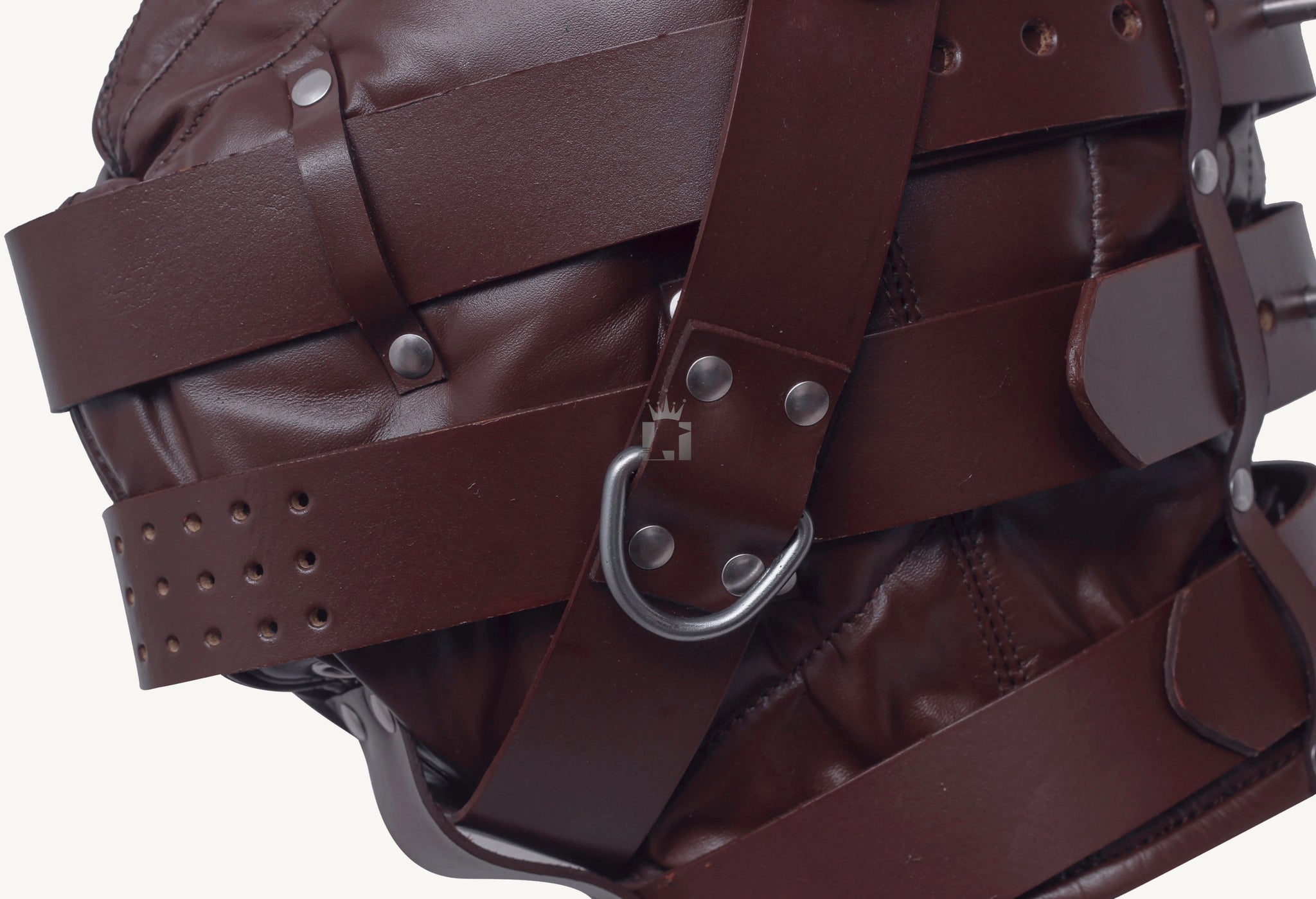 Close-up shot of a brown leather bondage hood with multiple straps , D'ring and revets on a white backgground