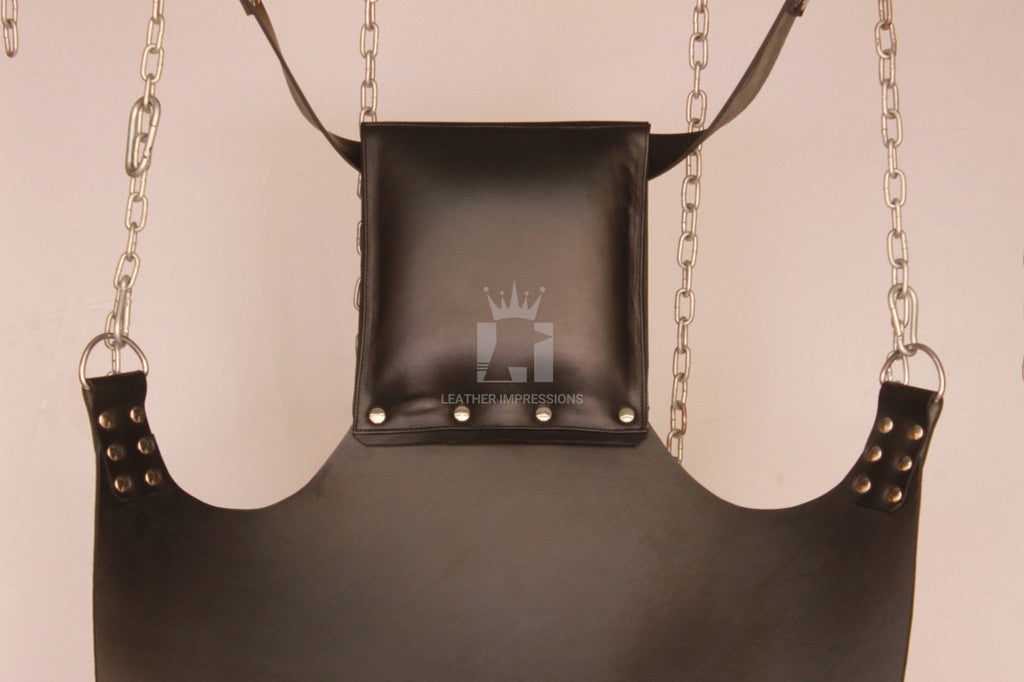 close-up shot of black leather sex swing pillow, D'rings and nickel-plated reverts in a white background