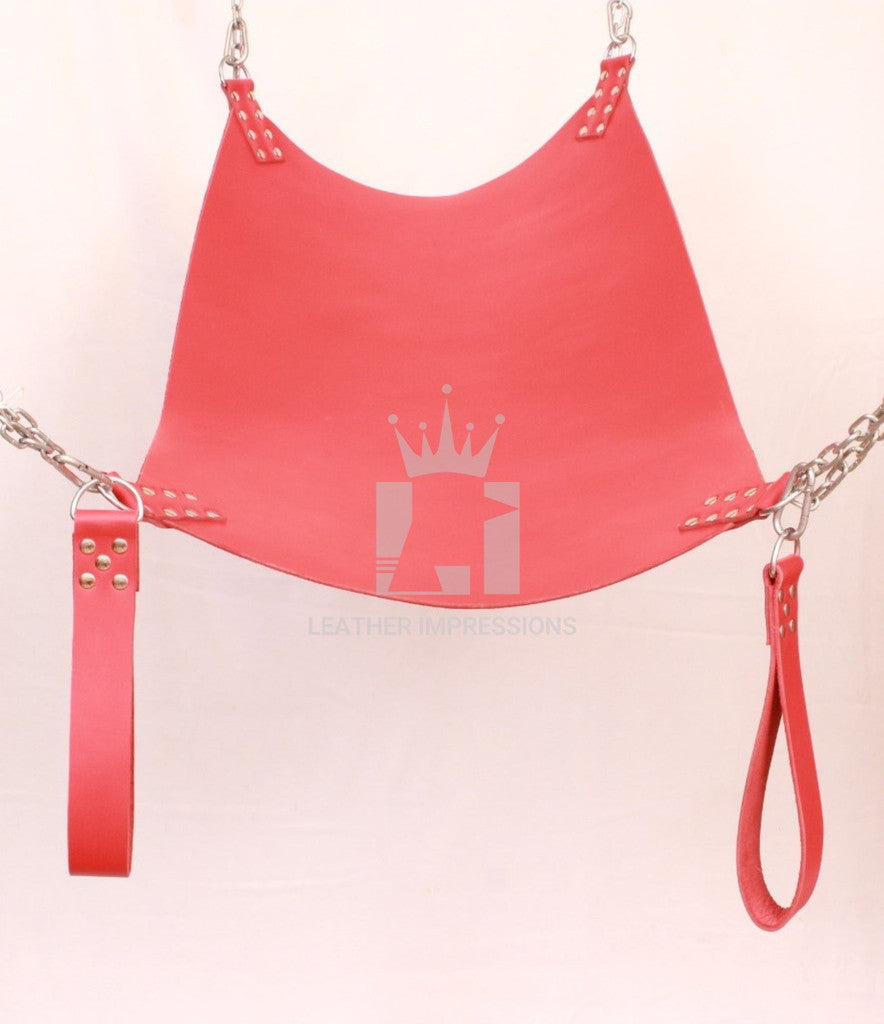 front angle far shot of red leater sex swing with nickel-plated reverts, leg loops and D'rings in a white background