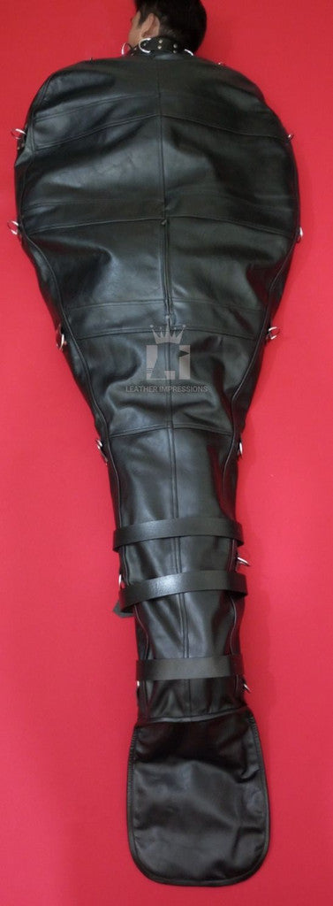 front angle view of backside of the handmade leather bondage sleepsack on red surface with straps