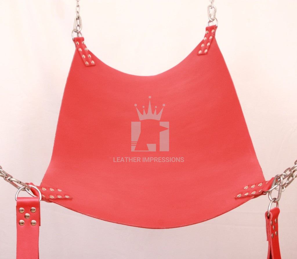 front angle view of red leather sex swing with nickel-plated reverts, d'rings and leg loops in a white background