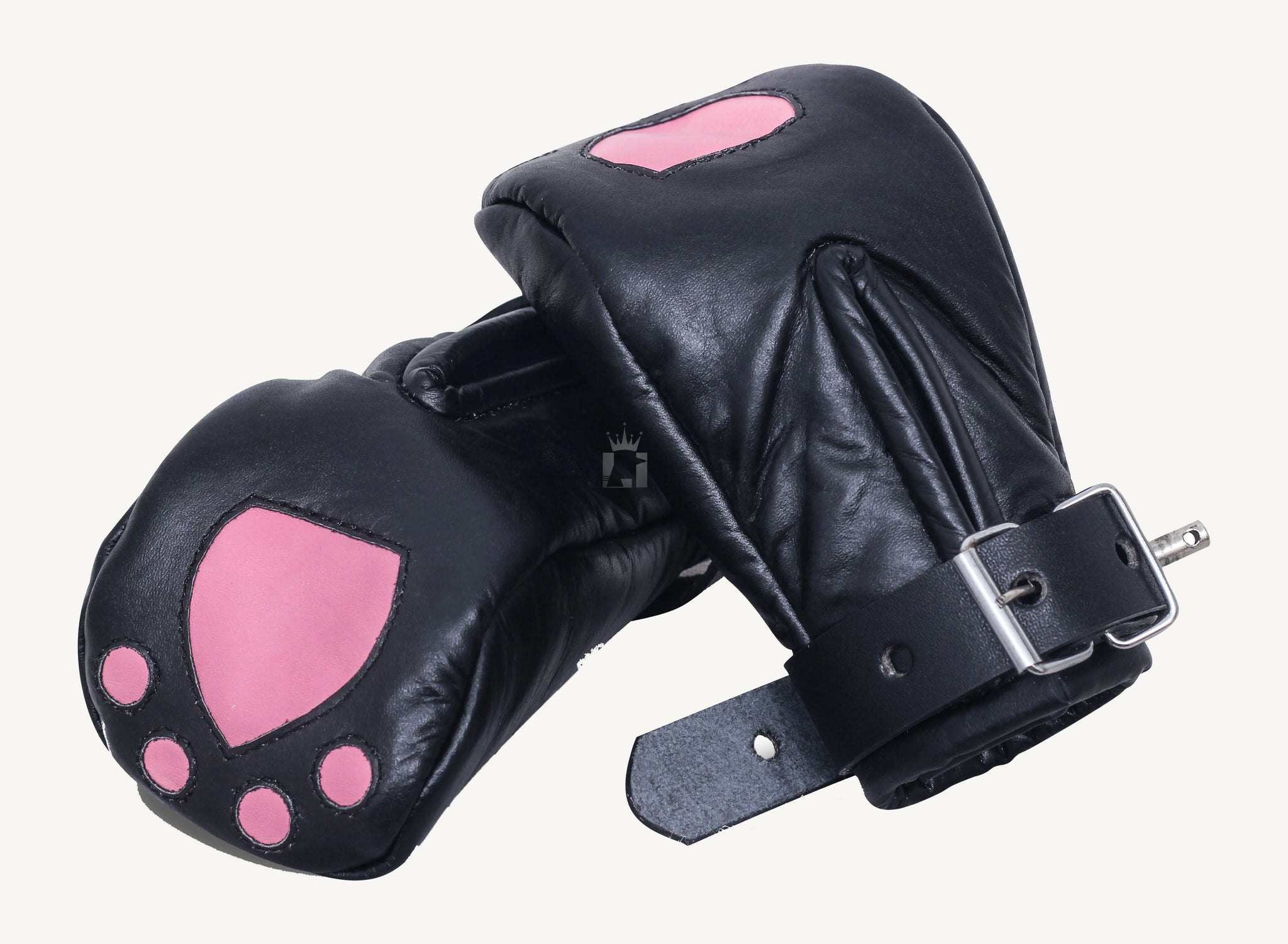 A side view of a pair of black leather bondage mittens styled like cat paws, featuring pink paw pad accents on the top and bottom. The bondage mittens are slightly curved with visible stitching and thick buckled wrist straps for a snug and secure fit.