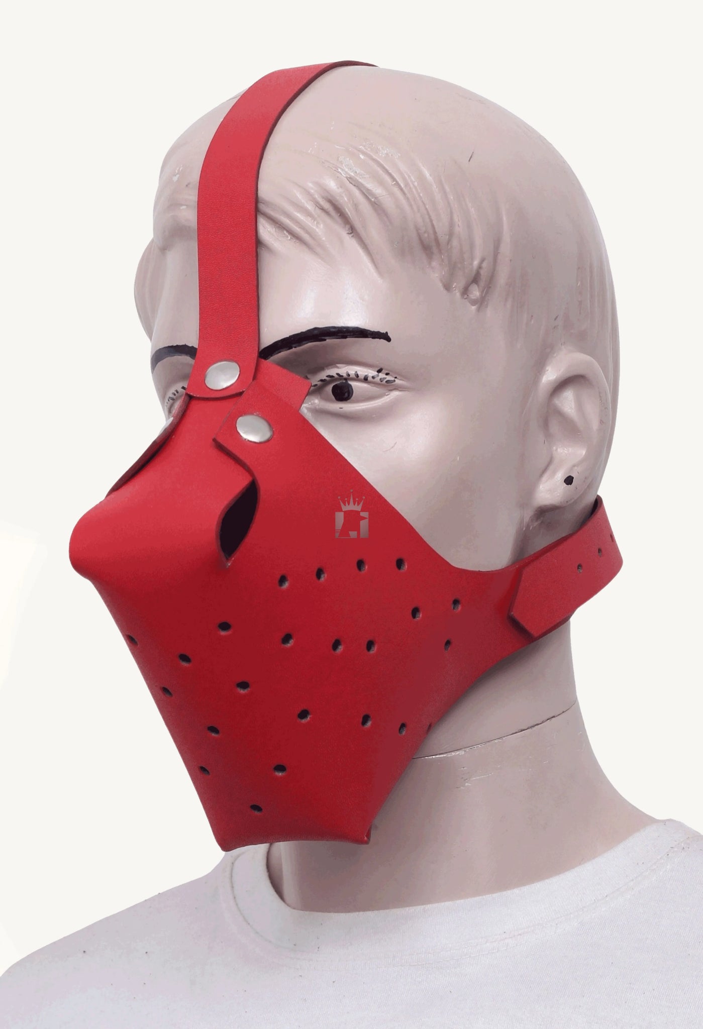  A three-quarter view of a mannequin wearing the red leather dog face muzzle, providing a clear look at the mask's shape and how the straps are attached.